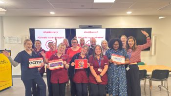 NICTN team photo with #Red4research signs