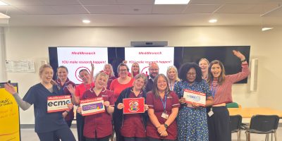 NICTN team photo with #Red4research signs