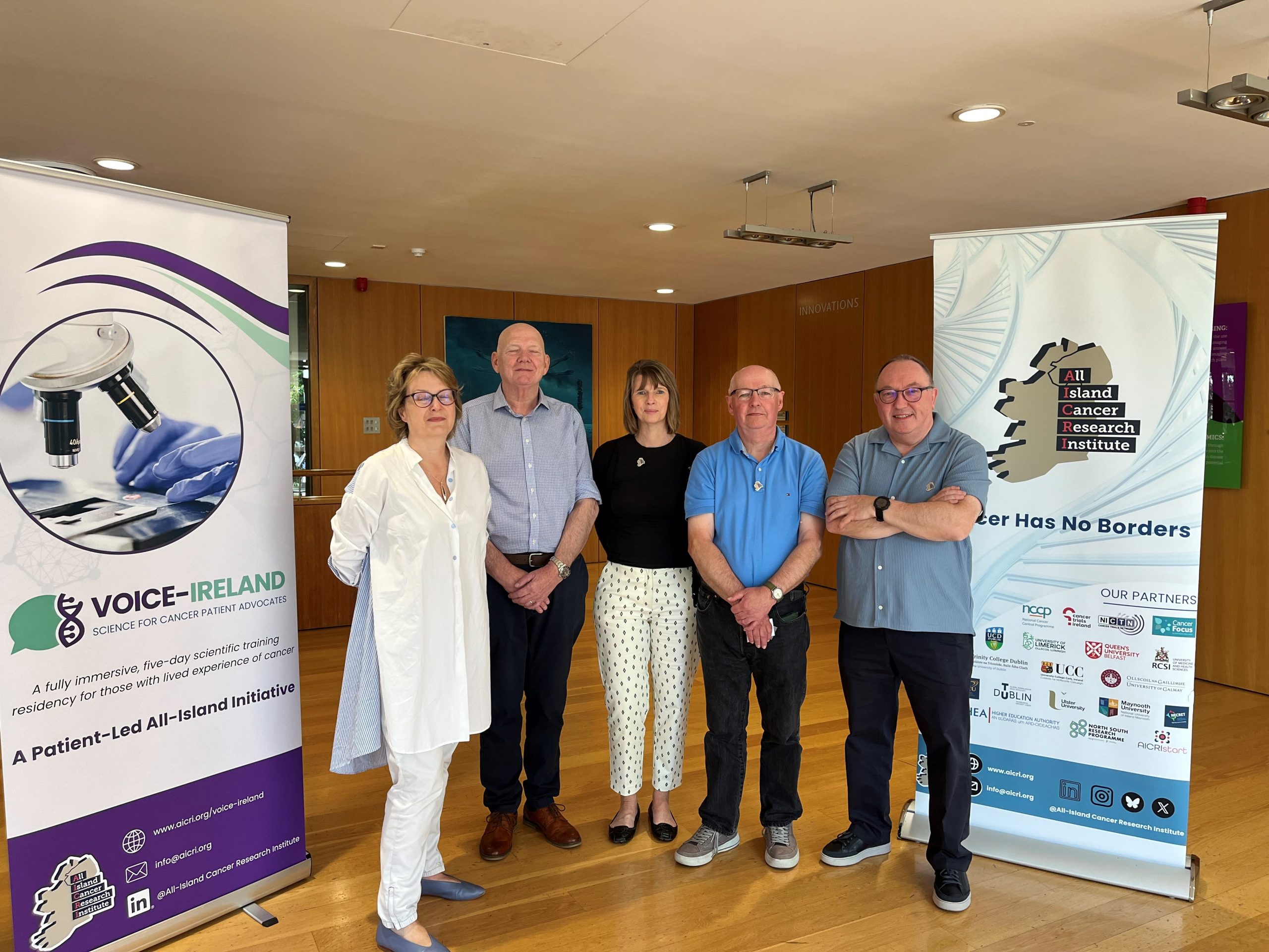 Debbie Keatley, James Caldwell, Ashley Hurst, Denver Lynn and Aidan McCormick Patient Advocates from NICRCF at VOICE Ireland course. Standing beside the AICRI and Voice Ireland pop up banner